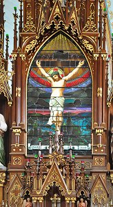 Painted glass window above altar